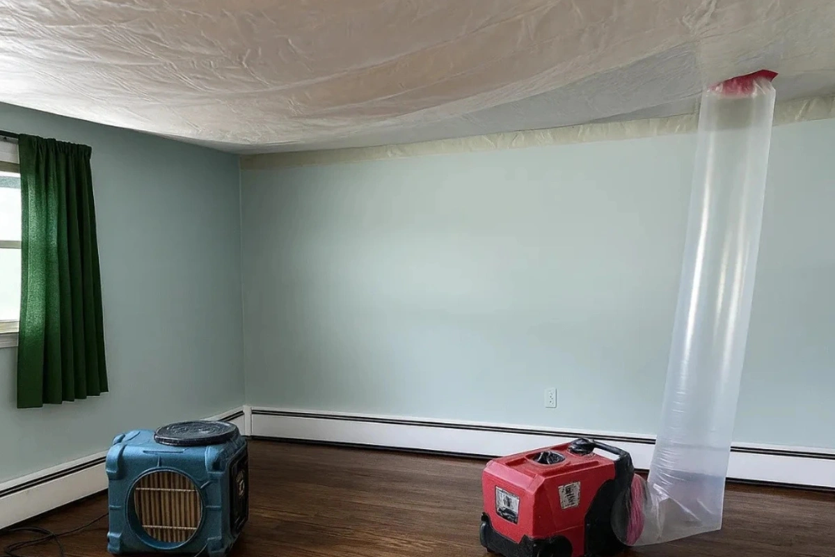 Room with drying equipment and a ceiling containment setup used to control moisture during professional dehumidification services in New Jersey.